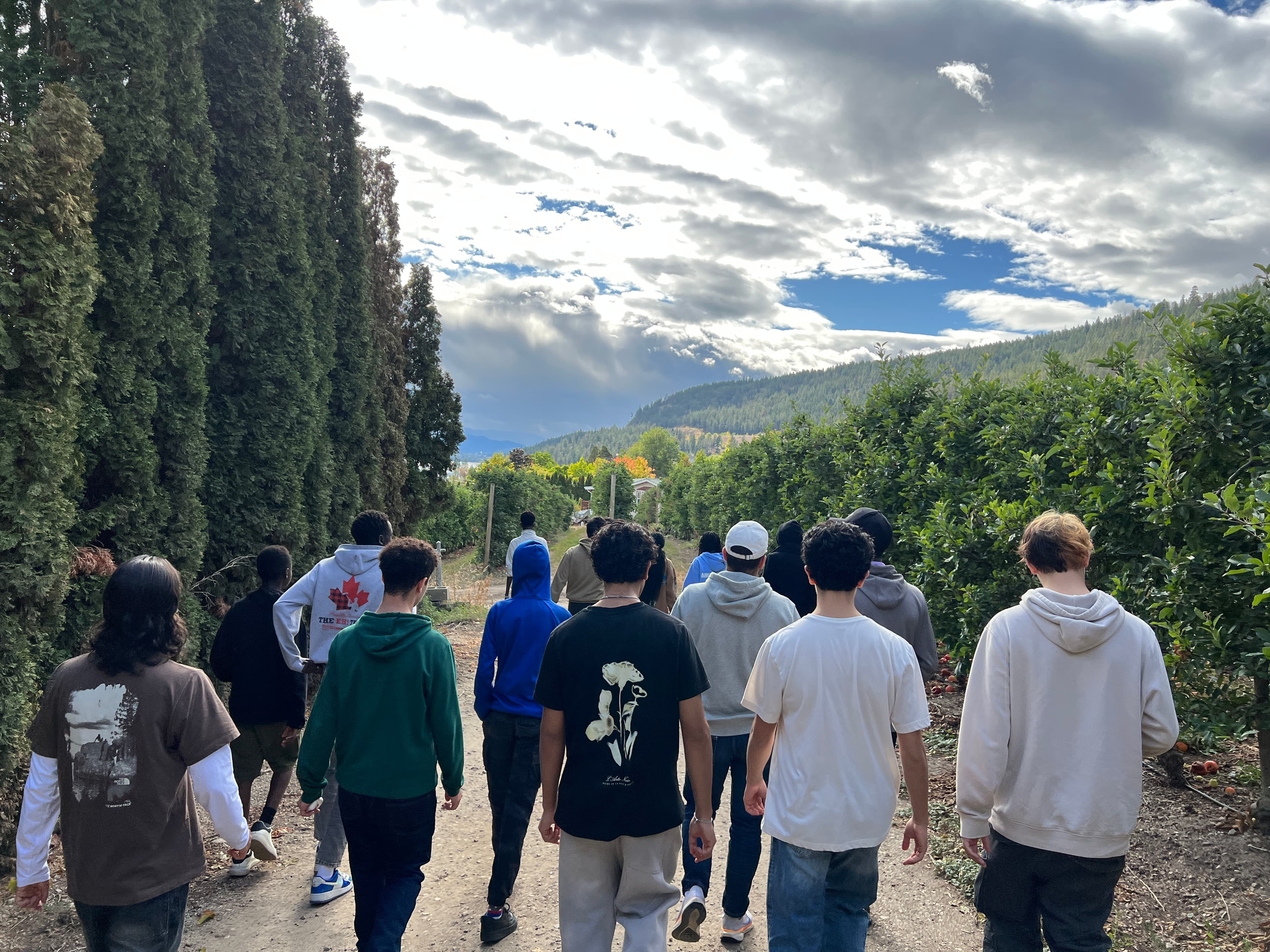 Youth walking together up a trail above the Okanagan hills